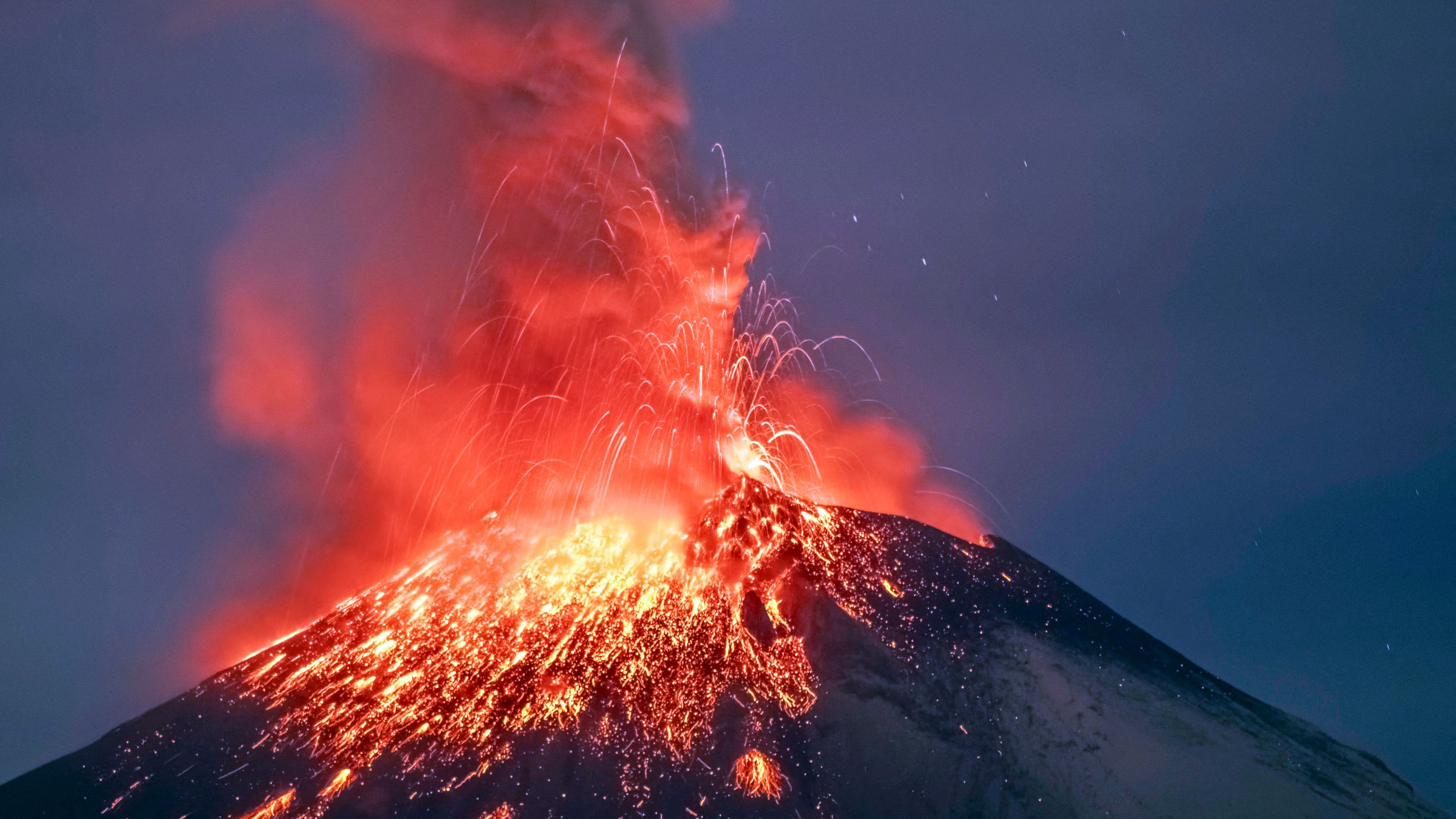 Incandescent materials, ash and smoke are spewed from the Popocatepetl volcano as seen from thr Santiago Xalitzintla community, state of Puebla, Mexico, on May 22, 2023.