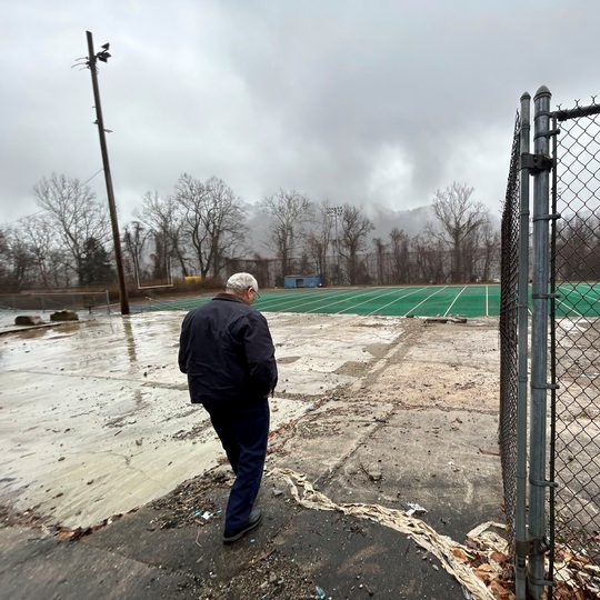 Montgomery mayor Greg Ingram walks through the empty stands of the old WVU Tech football field, which overlooks a city that has struggled since the university left.