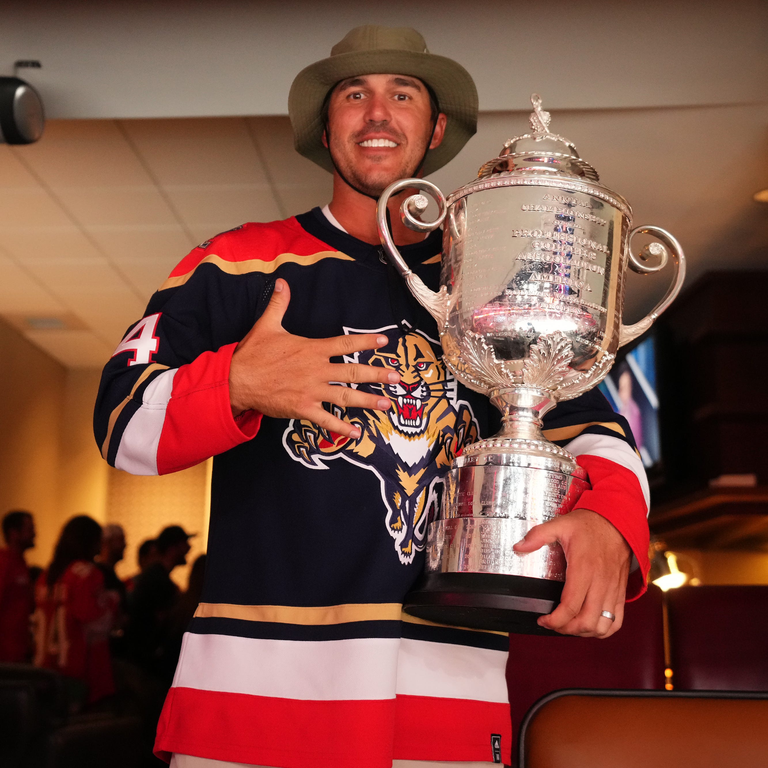 Pro golfer Brooks Koepka poses with the Wanamaker Trophy while attending game three of the Eastern Conference Finals of the 2023 Stanley Cup Playoffs between the Florida Panthers and the Carolina Hurricanes at FLA Live Arena.