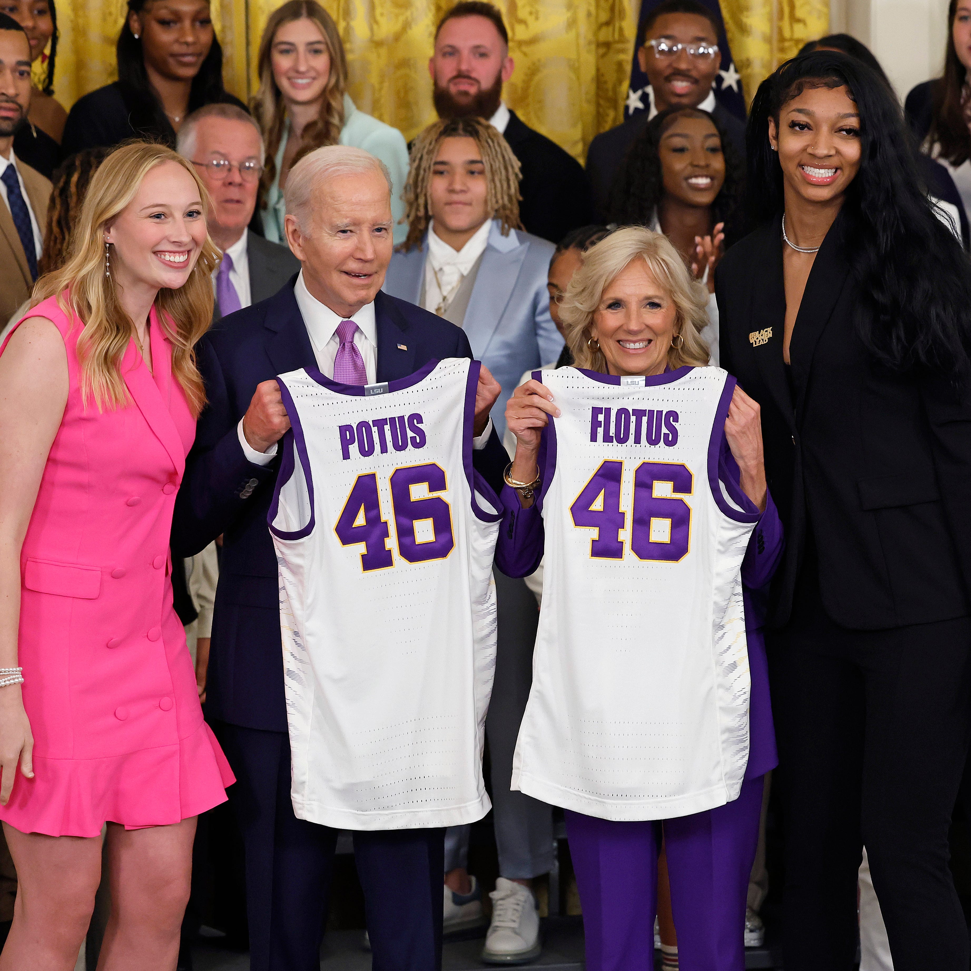 President Joe Biden and first lady Jill Biden pose for photographs with LSU players Emily Ward, left, and Angel Reese, right, during a White House ceremony honoring the Tigers winning the NCAA women's basketball tournament.