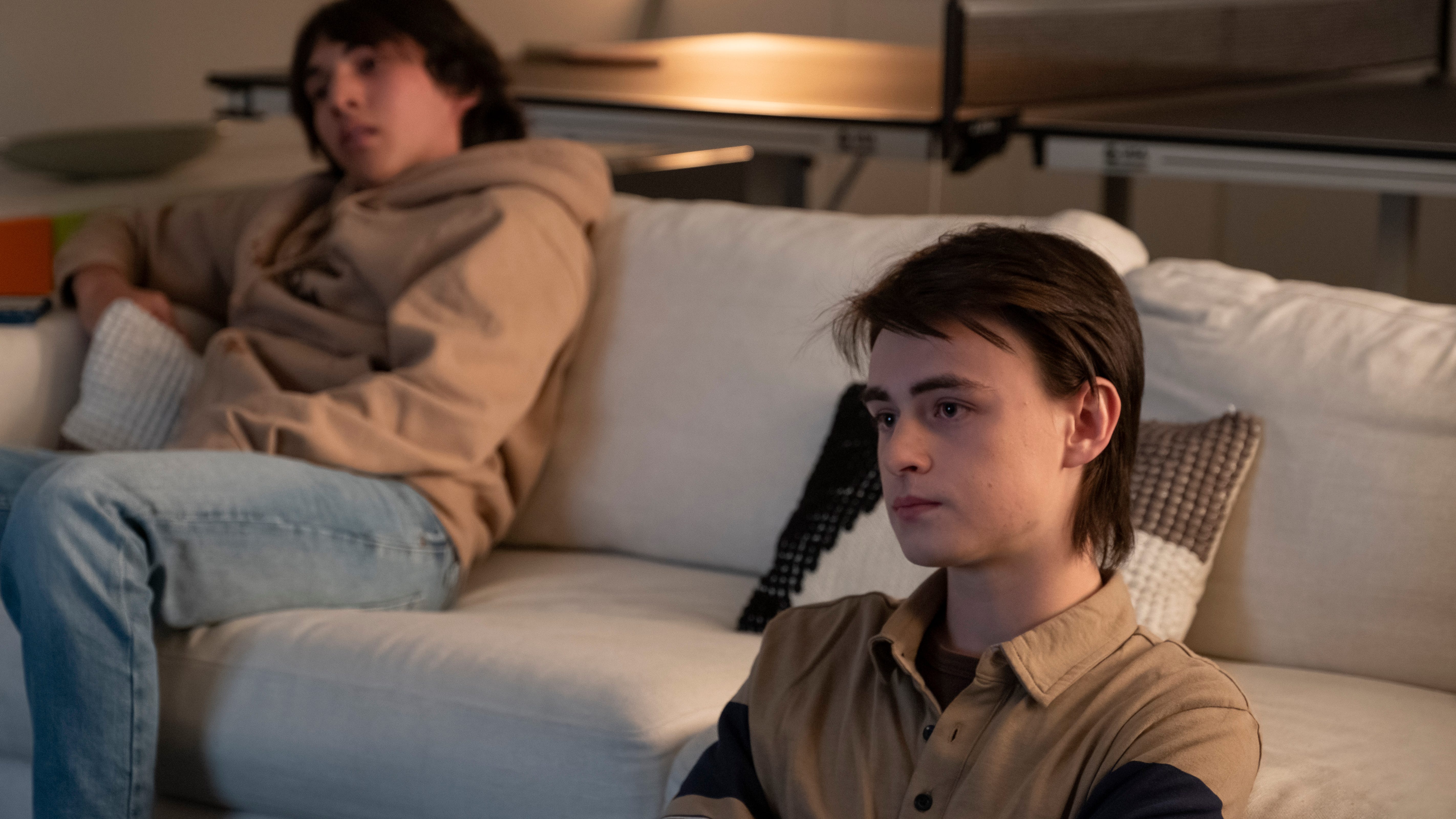 Barry Berkman's grown son John (Jaeden Martell) watches "The Mask Collector," a movie distorting his father's real history.