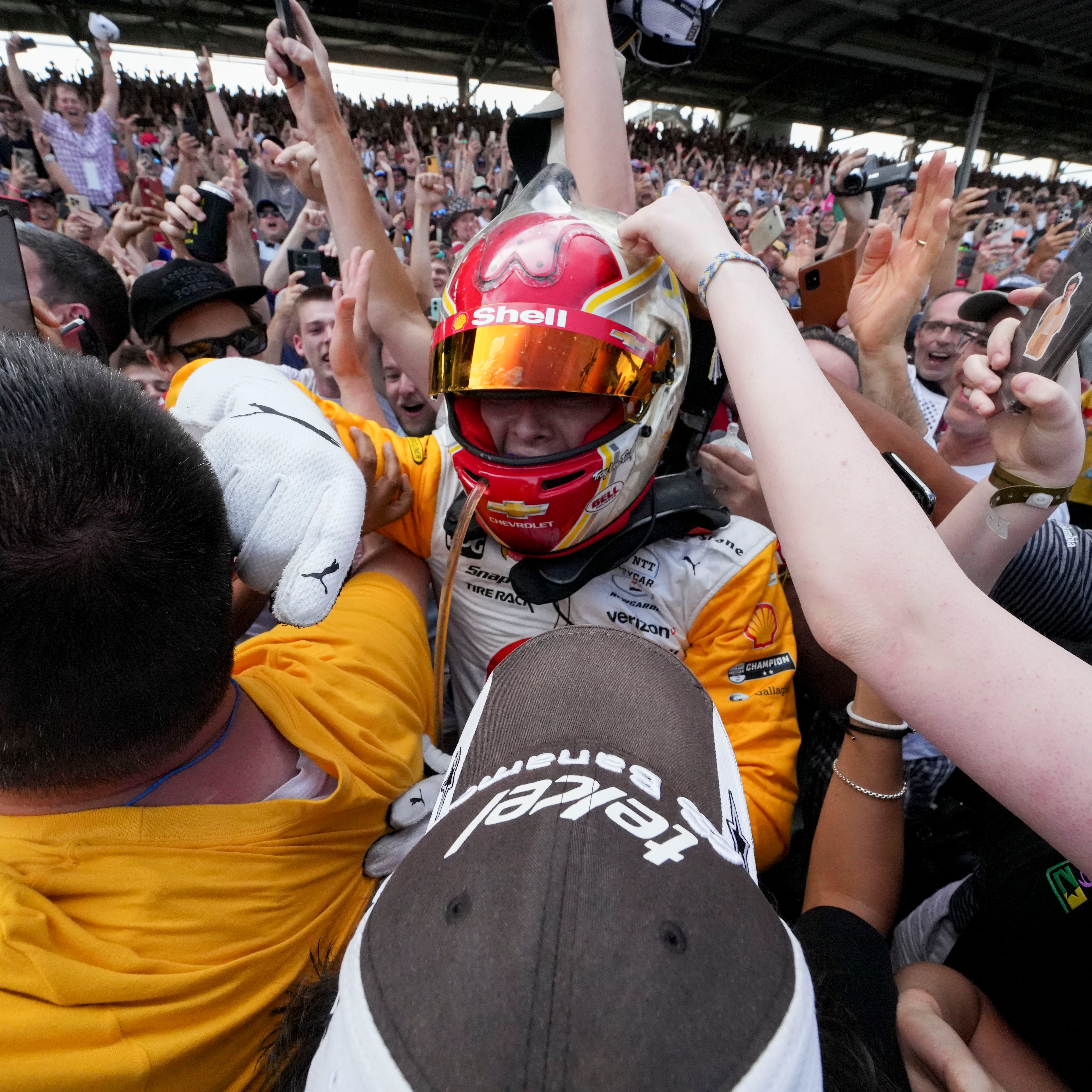 Team Penske driver Josef Newgarden (2) celebrates with fans Sunday, May 28, 2023, after winning the 107th running of the Indianapolis 500 at Indianapolis Motor Speedway.