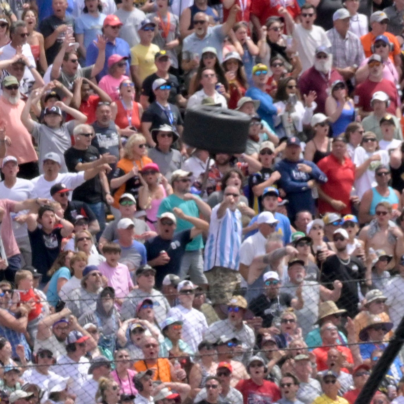 A wheel flies near a section of grandstand in the second turn after a collision between Andretti Autosport driver Kyle Kirkwood (27) Arrow McLaren SP driver Felix Rosenqvist (6) on Sunday, May 28, 2023, during the 107th running of the Indianapolis 500 at Indianapolis Motor Speedway.