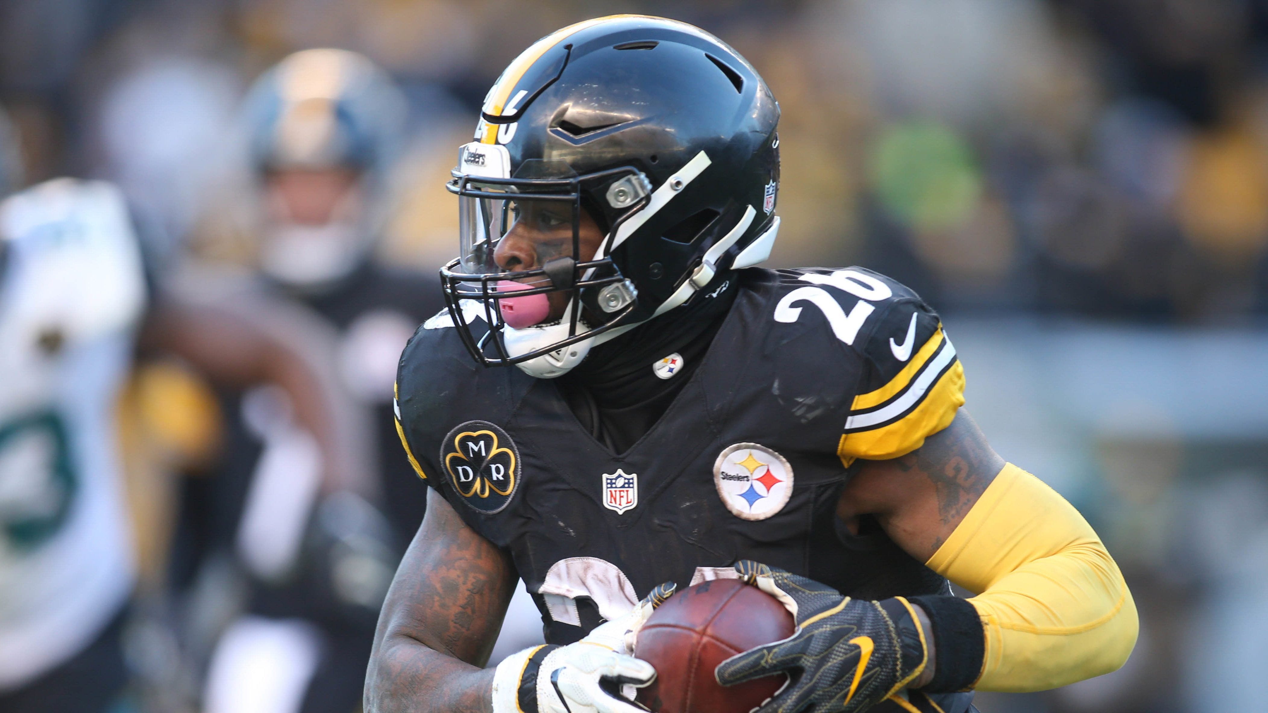 The file photo shows Pittsburgh Steelers running back Le'Veon Bell running with the ball during a game.