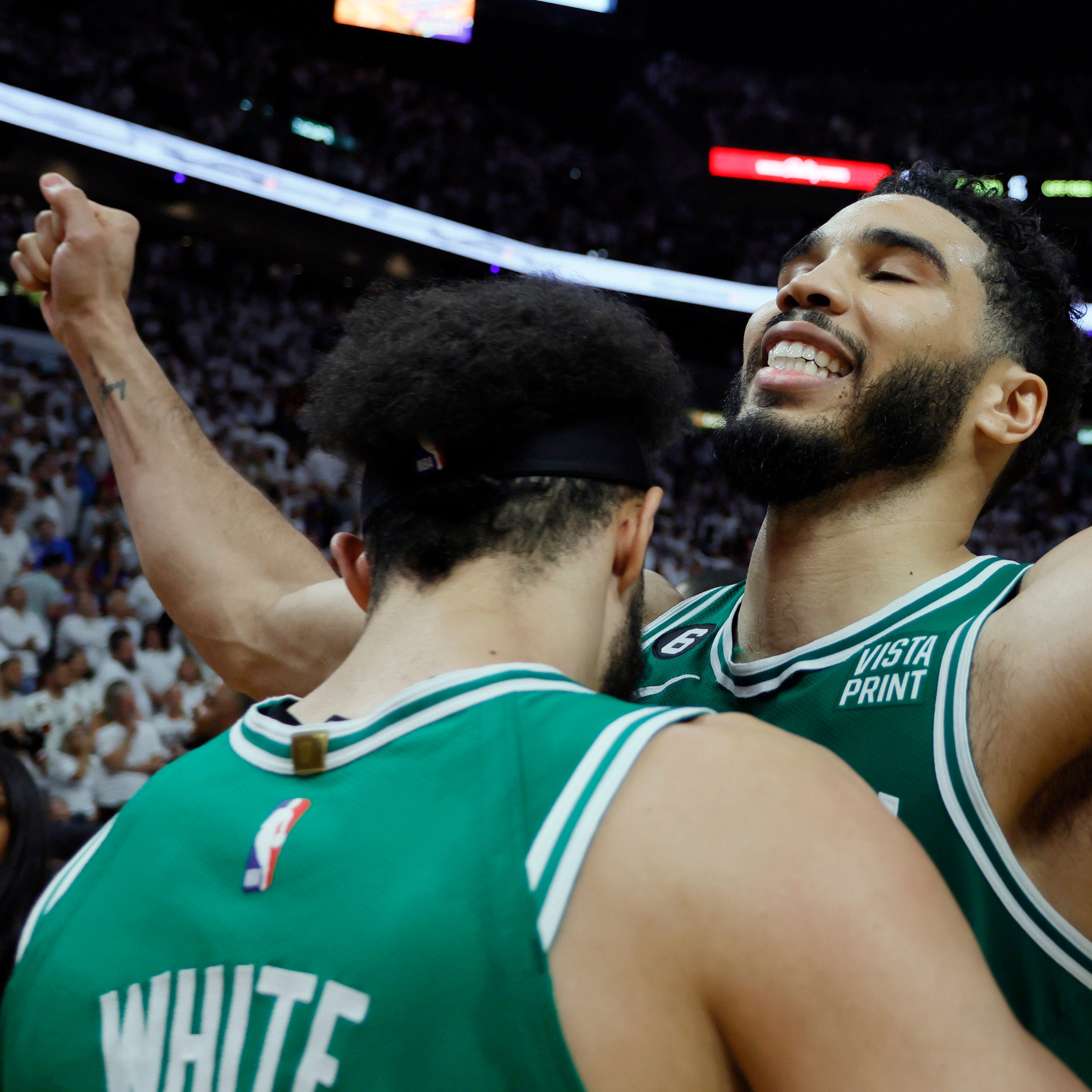 The Boston Celtics' Derrick White celebrates with Jayson Tatum after defeating the Miami Heat in Game 6.