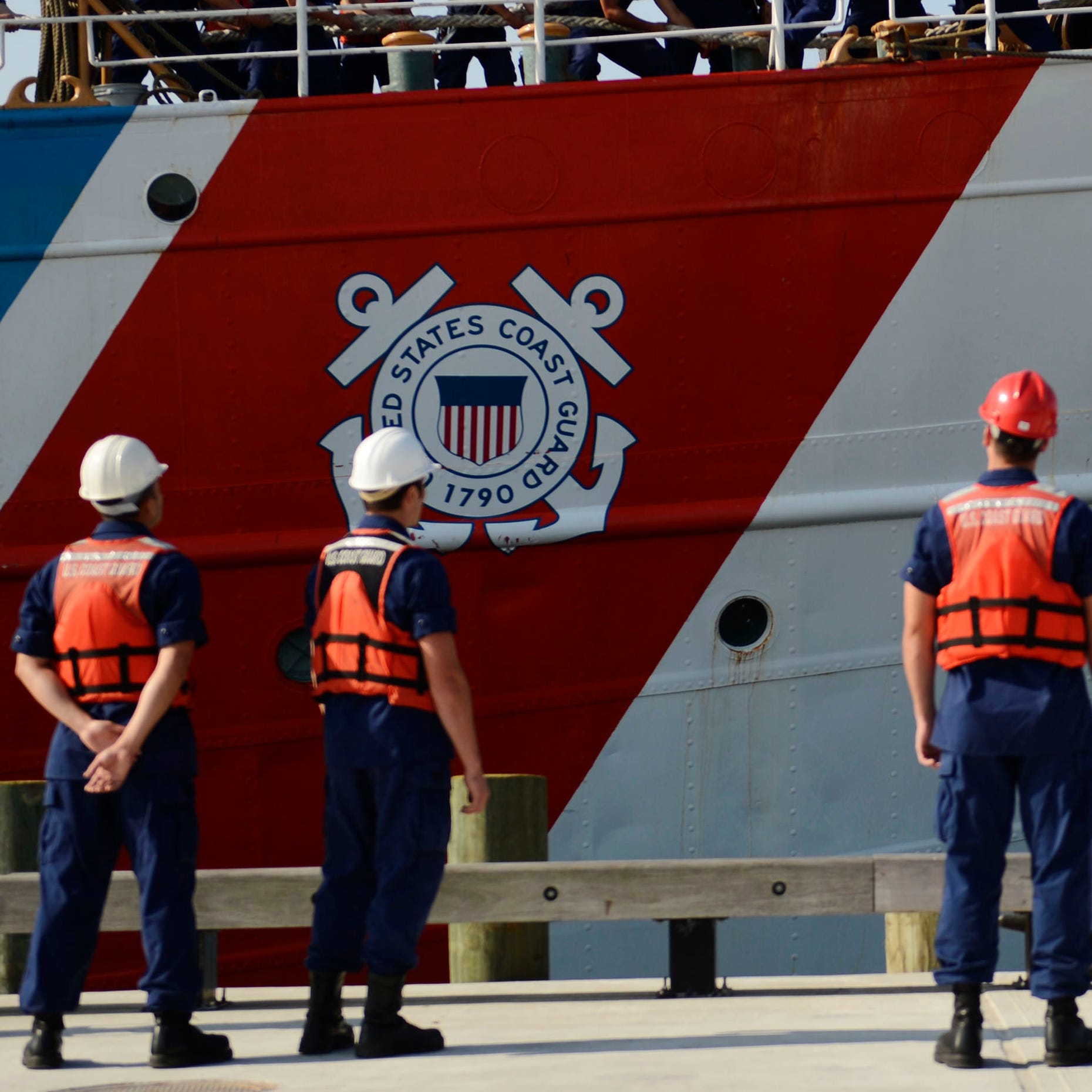 A crew from Coast Guard Station New London, Connecticut, waits to handle dock lines for the United States Coast Guard Barque Eagle at City Pier.
