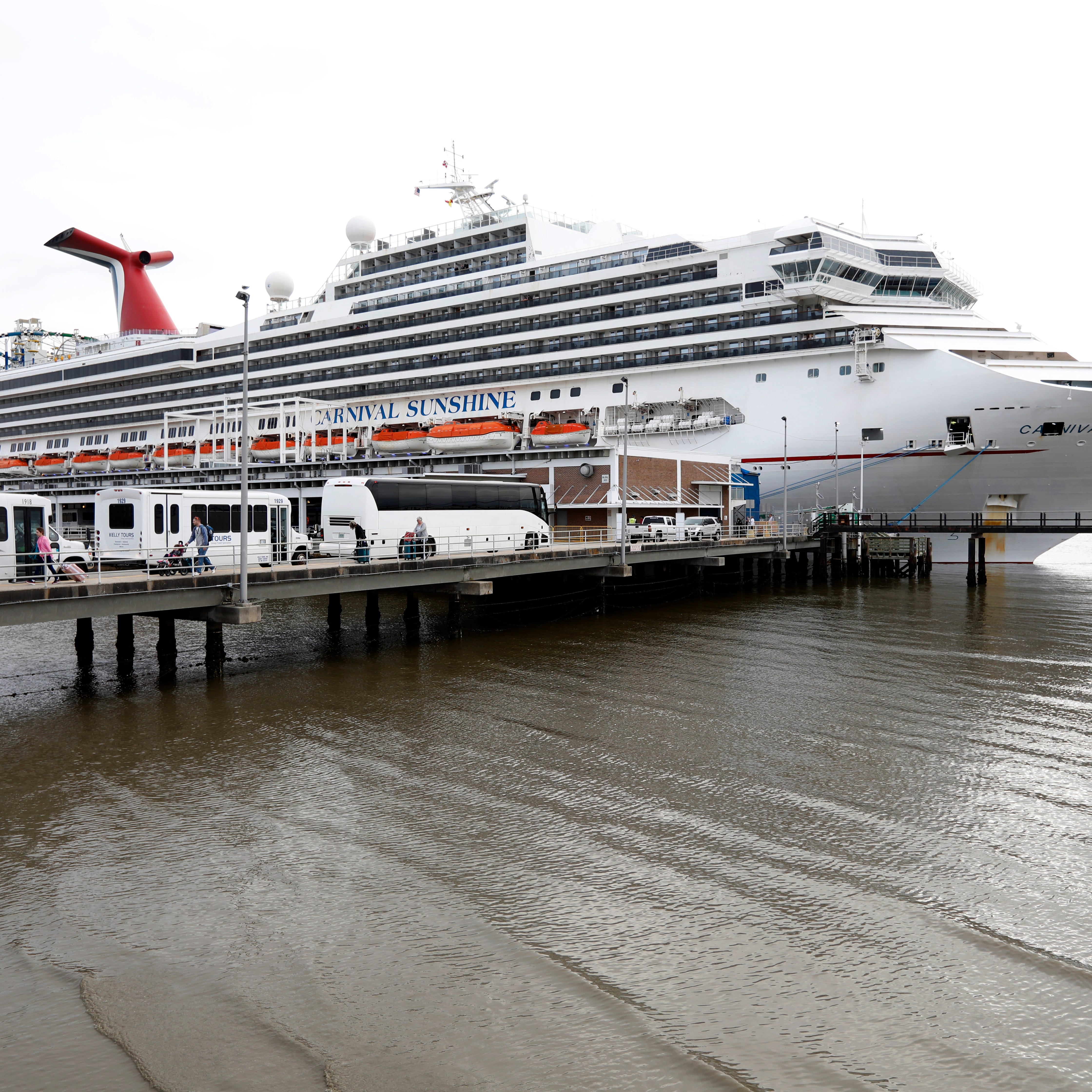 Passengers disembark from the Carnival Sunshine cruise ship Monday, March 16, 2020, in Charleston, S.C.