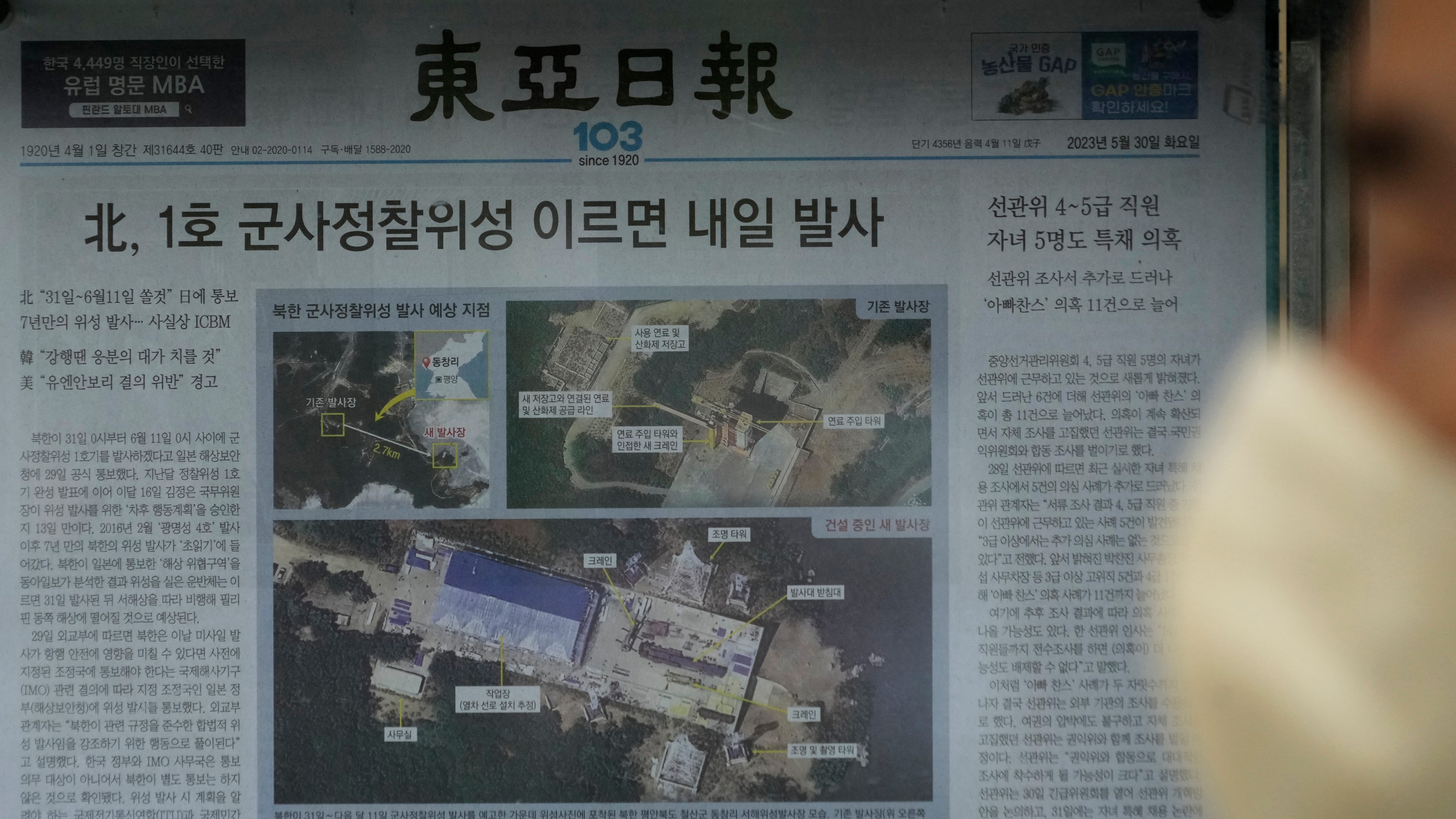 A local newspaper showing file images of the Sohae Satellite Launching Station in Tongchang-ri, North Korea, is displayed in Seoul, South Korea, Tuesday, May 30, 2023. North Korea said Tuesday it would soon launch its first military spy satellite.