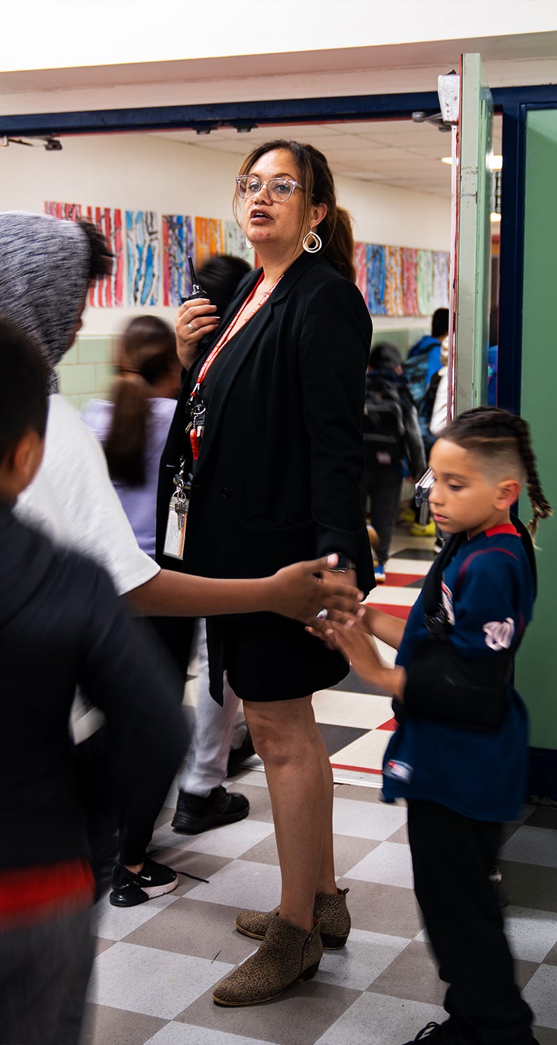 April 28, 2023; Alexandria, VA, USA; Jasibi Crews, principal of Cora Kelly School, monitors students as they begin to go home after a school assembly at the end of the day Friday, April 28, 2023.. Mandatory Credit: Josh Morgan-USA TODAY [Via MerlinFTP Drop]