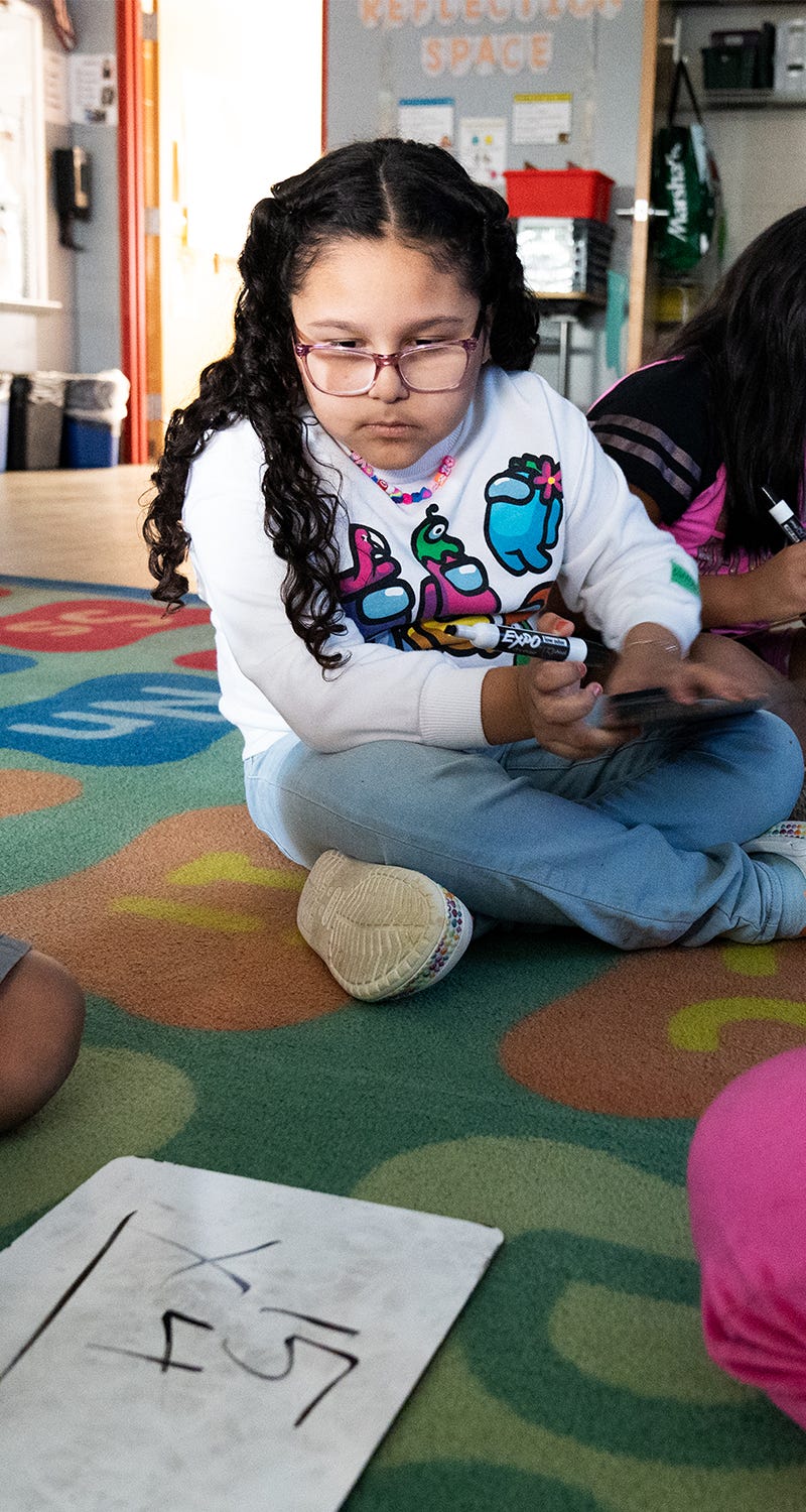 April 25, 2023; Alexandria, VA, USA; Ashley Soto, a third grader at Cora Kelly School, observes as another student complete a math problem during after-school instruction Tuesday, April 25, 2023.. Mandatory Credit: Josh Morgan-USA TODAY [Via MerlinFTP Drop]