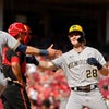 The Milwaukee Brewers score two runs on a pair of fielder's choice grounders in 11th inning to eke out win over Cincinnati Reds