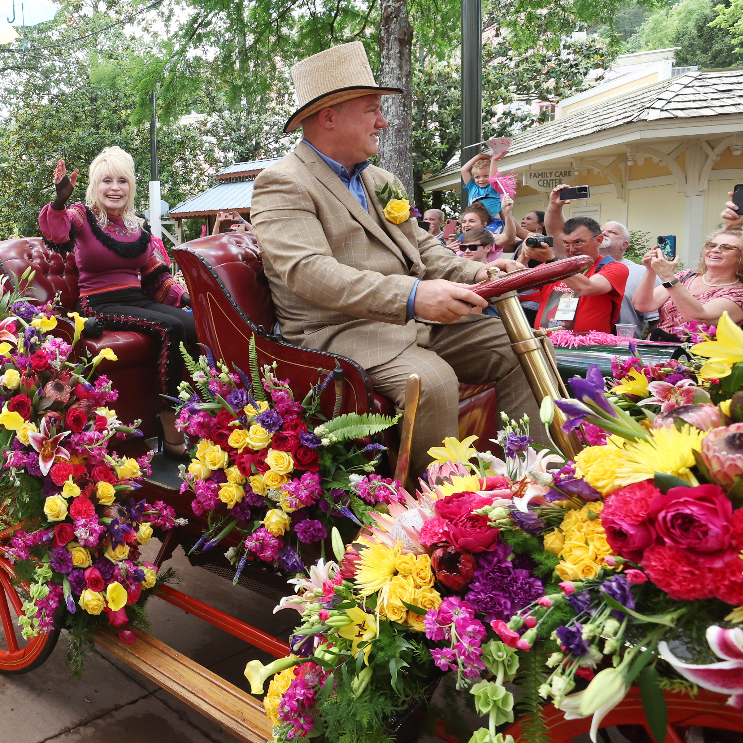 Dolly Parton waves to fans during a parade at Dollywood on May 12, the day Big Bear Mountain opened at the park. Barring rain or extreme cold, parades are held when she visits, so all guests have the opportunity to see her.
