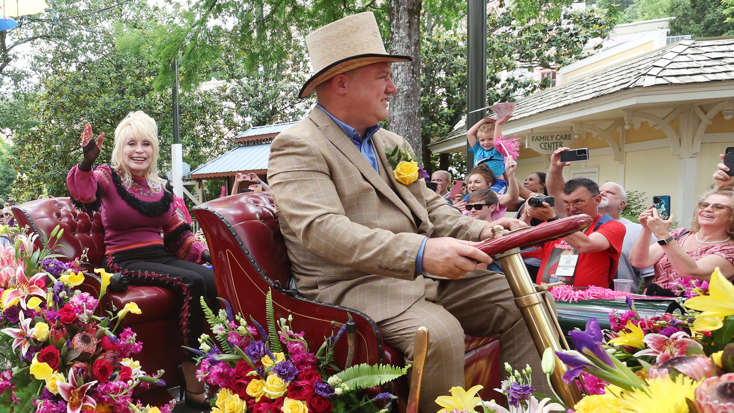 Dolly Parton waves to fans during a parade at Dollywood on May 12, the day Big Bear Mountain opened at the park. Barring rain or extreme cold, parades are held when she visits, so all guests have the opportunity to see her.