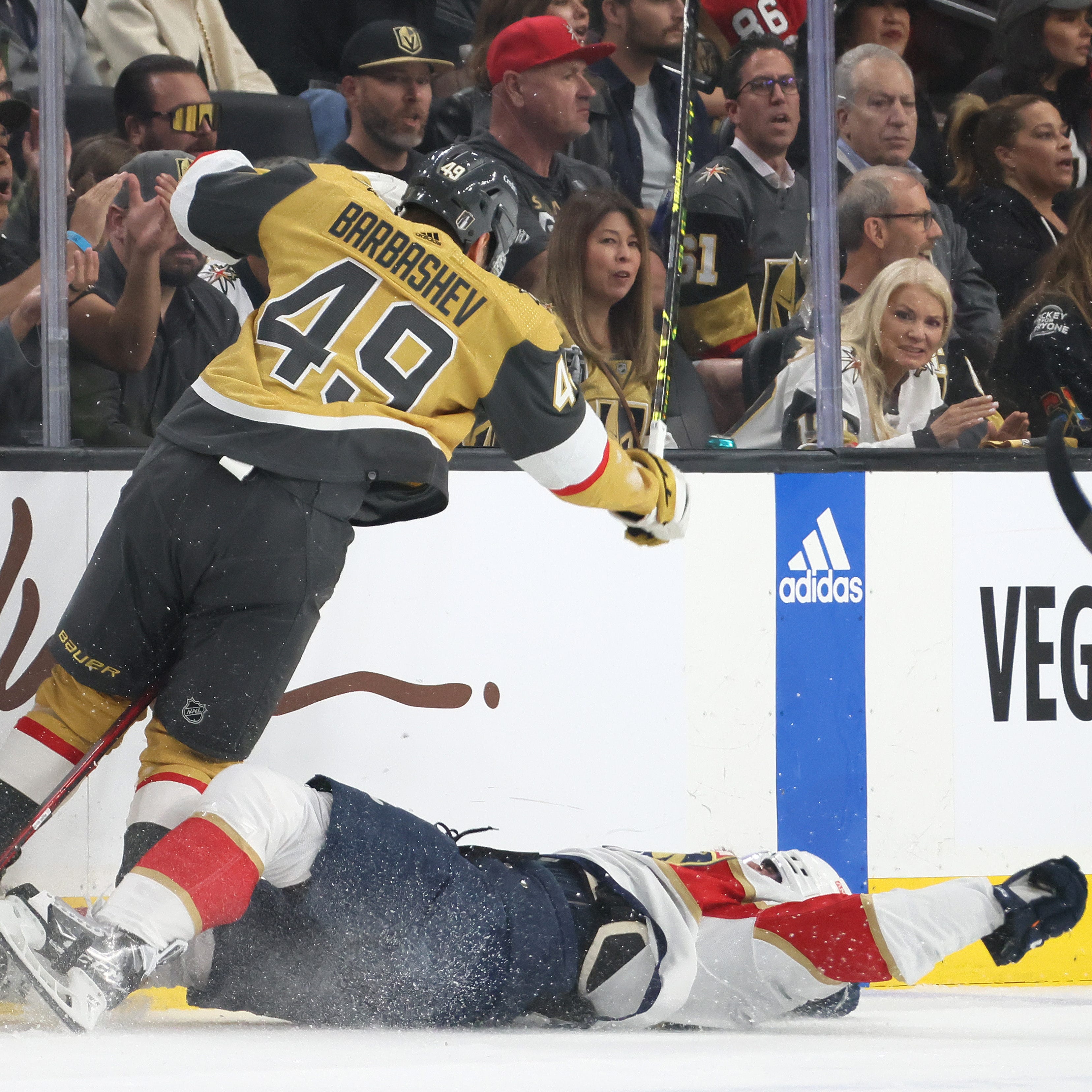 Radko Gudas is checked by Ivan Barbashev during the first period.