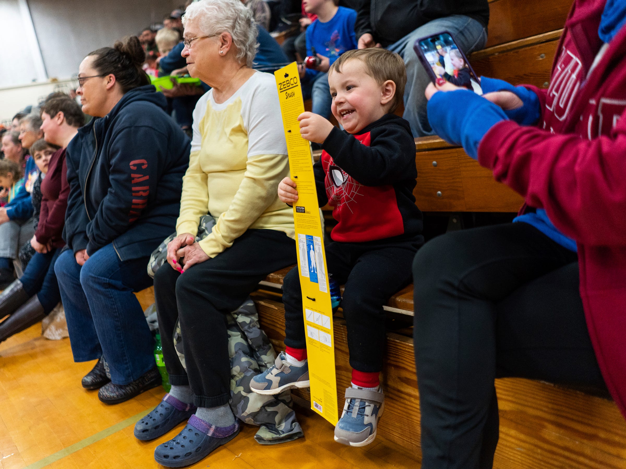 Ethen Clarke, of Gaylord, excitedly looks over a fishing pole he won during the 65th annual Kids Tackle Party held by the Tahquamenon Sportsmen's Club in Newberry on Saturday, April 22, 2023, at Newberry High School in Michigan's Upper Peninsula.