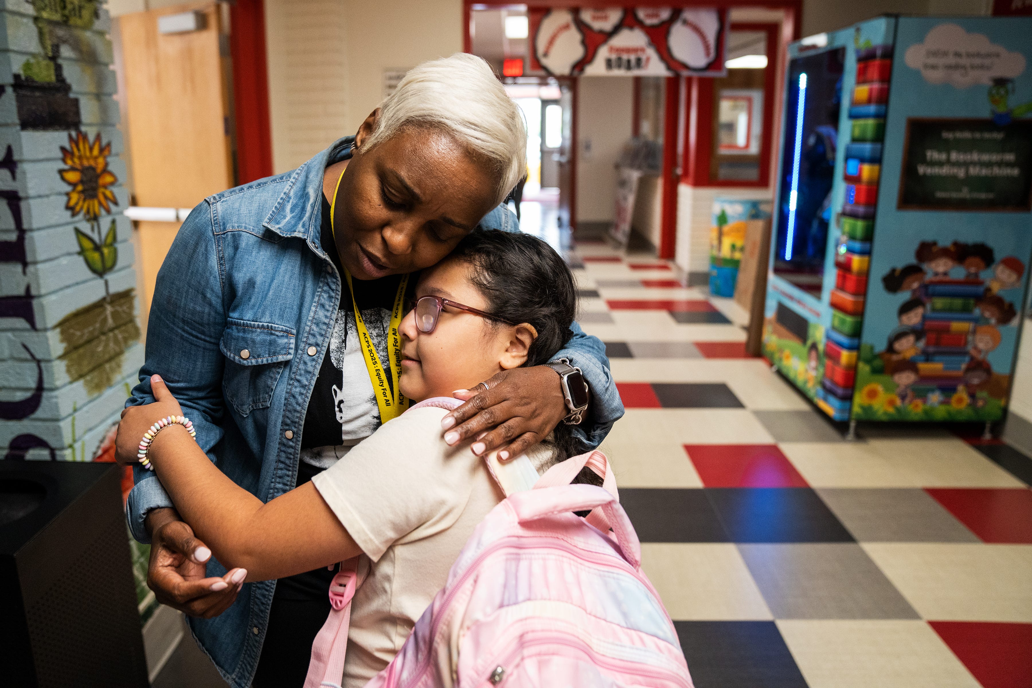 Ashley Soto, a third grader at Cora Kelly Elementary in Alexandria, Va., hugs Andrea Hill, literacy instructional coach, during her last day of school Thursday, June 8, 2023. 