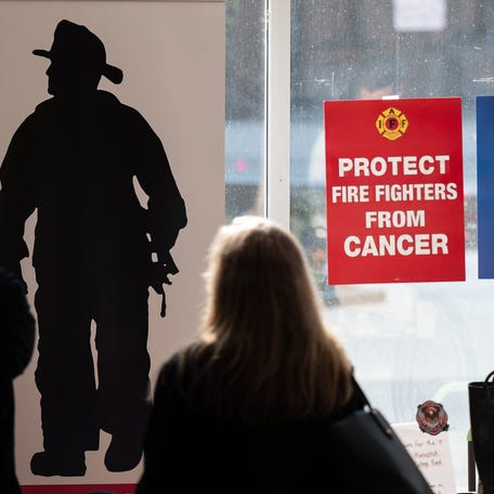 Signs adorn the windows prior to the screening of "Burned," a film that tells the story of Diane Cotter of Worcester's fight to expose PFAS in firefighting gear on Sunday June 11, 2023 at the Hanover Theatre.