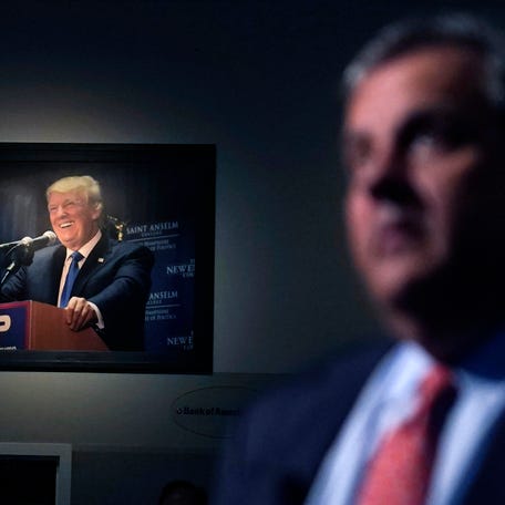 A photograph of former President Donald Trump hangs on the wall as Republican presidential candidate, former New Jersey Gov. Chris Christie listens to a question during a gathering, Tuesday, June 6, 2023, in Manchester, N.H. Christie filed paperwork Tuesday formally launching his bid for the Republican nomination for president after casting himself as the only candidate willing to directly take on Trump. (AP Photo/Charles   Krupa) ORG XMIT: PNA211