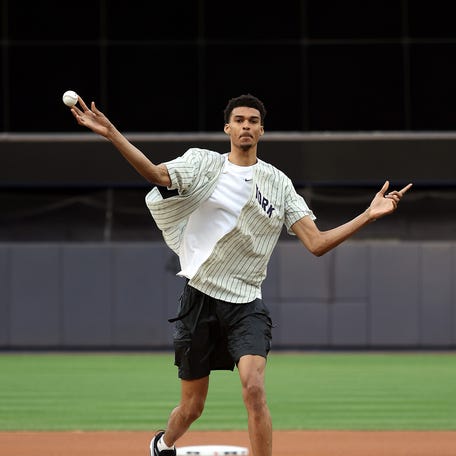 Victor Wembanyama, projected first round pick in the 2023 NBA draft, throws out the ceremonial first pitch prior to the game between the Seattle Mariners and the New York Yankees at Yankee Stadium on June 17, 2023 in New York City.