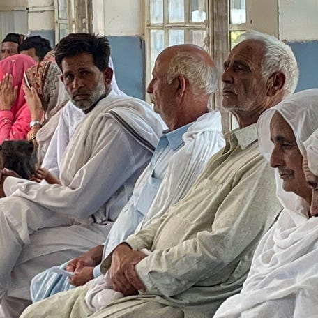 In this picture taken on June 20, 2023, relatives of migrants, who went missing after an overloaded trawler capsized and sank in the Ionian Sea, wait to provide DNA samples at a hospital in Bandli village, in Pakistan-administered Kashmir. Death hangs over the Pakistan village of Bandli like a shroud, as residents absorb news that as many as 24 young local men may be among hundreds feared drowned in last week's Greek migrant boat tragedy. (Photo by Sajjad   QAYYUM / AFP) (Photo by SAJJAD QAYYUM/AFP via Getty Images) ORIG FILE ID: AFP_33KF6WE.jpg