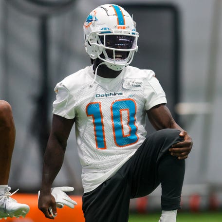 Miami Dolphins wide receiver Tyreek Hill (10) stretches during mandatory minicamp at the Baptist Health Training Complex.