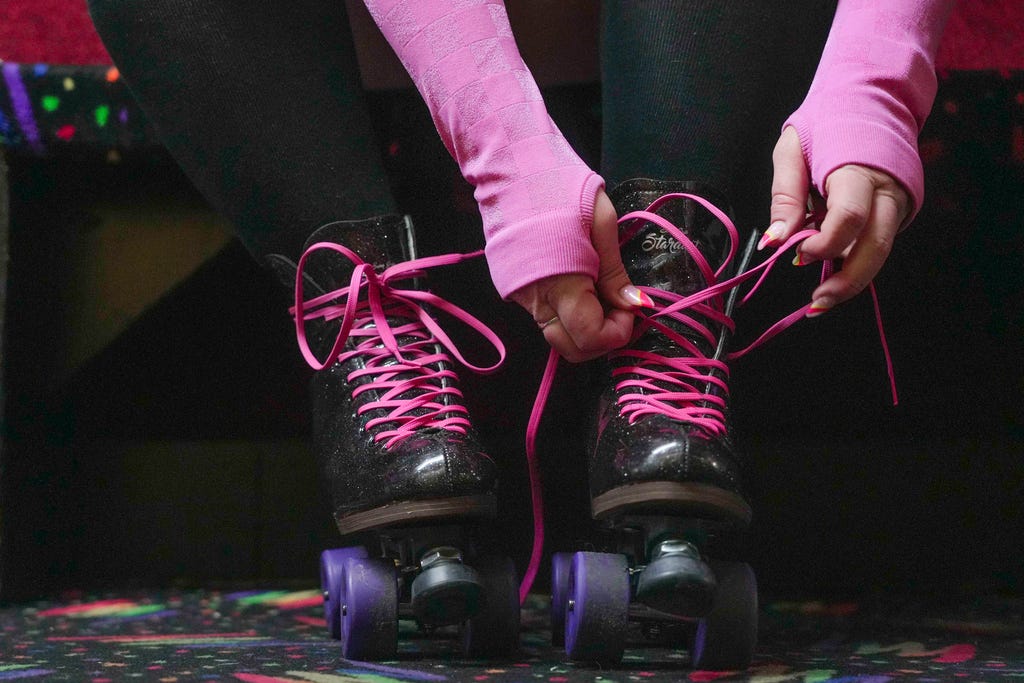 Kelly Mack ties the laces on her skates before hitting the rink for Rainbow Skate Night at Moonlight Rollerway in Glendale, Calif., on June 14, 2023.