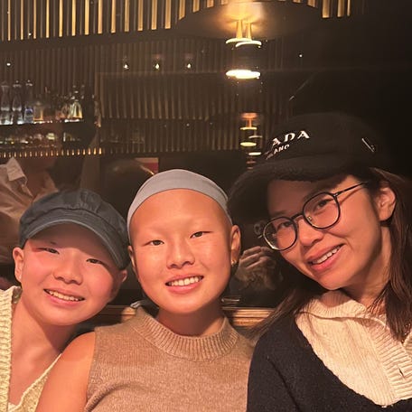 From left to right:  Madeline Lee, 13, her older sister Alison Lee, 17, and her mother Julie Yoo, 47.