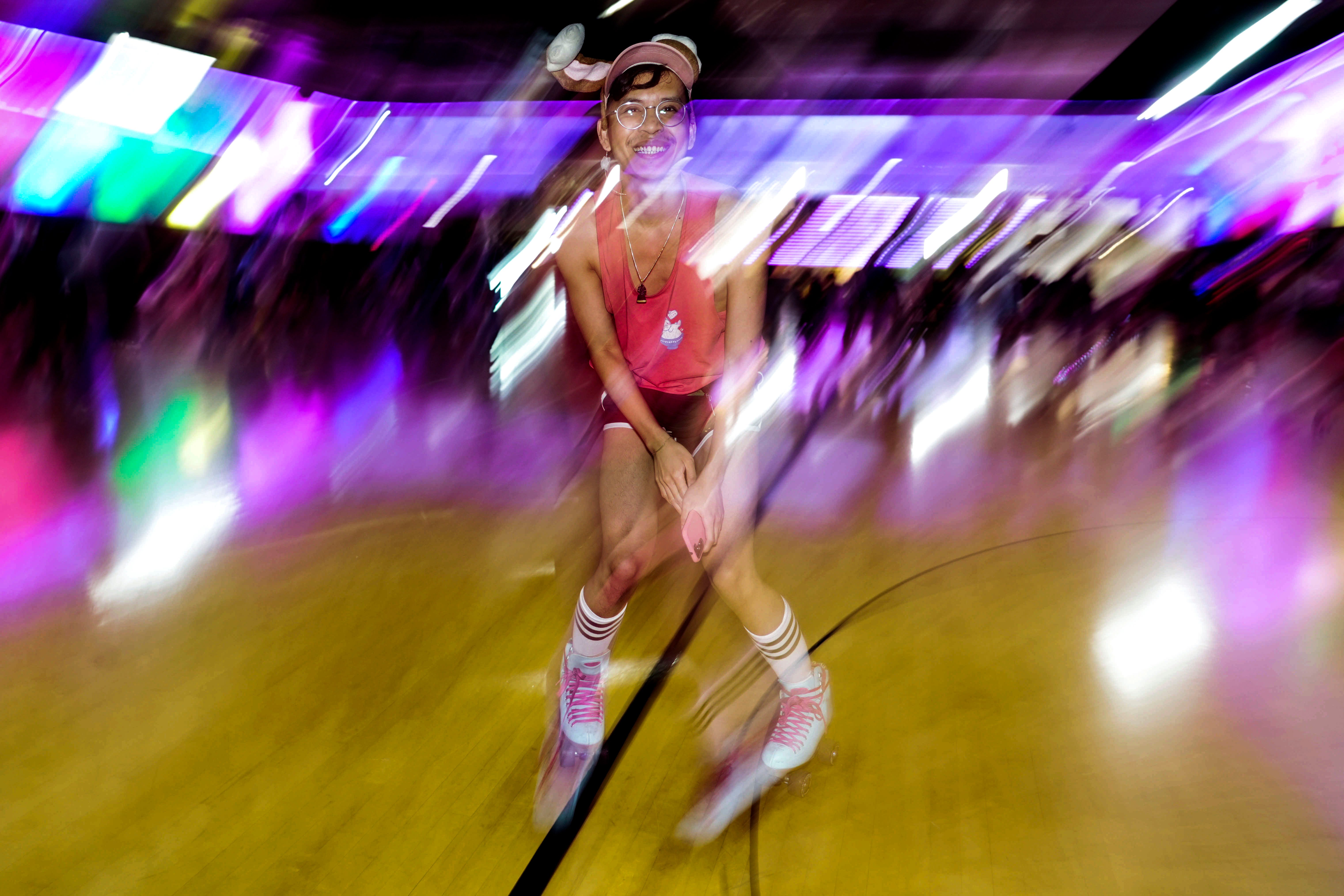 A skater skates backward at Moonlight Rollerway on Rainbow Skate Night, the longest LGBTQ+-friendly skating event in Los Angeles County.
