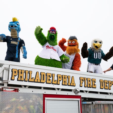 Mascots from professional Philadelphia sports teams cross over the repaired section of Interstate 95 as the highway is reopened Friday, June 23, 2023 in Philadelphia.  Workers put the finishing touches on an interim six-lane roadway that will serve motorists during construction of a permanent bridge.