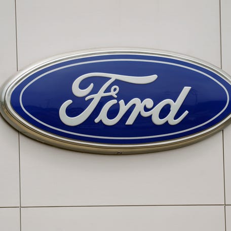 FILE - The Ford logo is seen on signage at a Ford dealership, Tuesday, July 27, 2021. The National Highway Traffic Safety Administration is investigating a Ford Motor Co. recall of more than a quarter-million Explorer SUVs in the U.S. after receiving complaints about repairs intended to prevent the vehicles from unexpectedly rolling away even while placed in 