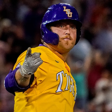 LSU Tigers designated hitter Cade Beloso points to the crowd after hitting a home run in the 11th inning against the Florida Gators.