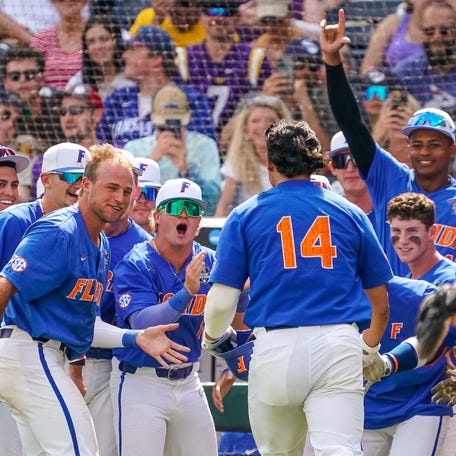 The Florida Gators dugout celebrates after Florida Gators first baseman Jac Caglianone (14) hit a home run against the LSU Tigers during the sixth inning at Charles Schwab Field Omaha.