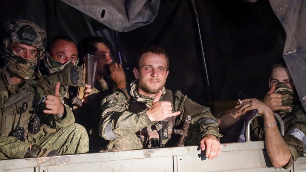 Members of the Wagner Group military company sit in their vehicle on a street in Rostov-on-Don, Russia, Saturday, June 24, 2023, as they prepare to leave an area at the headquarters of the Southern Military District.
