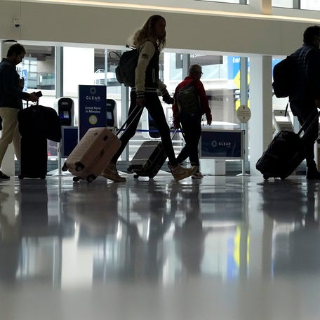 Travelers walk through a domestic terminal at San Francisco International Airport in San Francisco, Friday, May 26, 2023.