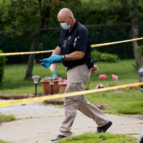 An investigator walks out of a home along Broadway Street, Sunday, June 25, 2023, in Newton, Mass.