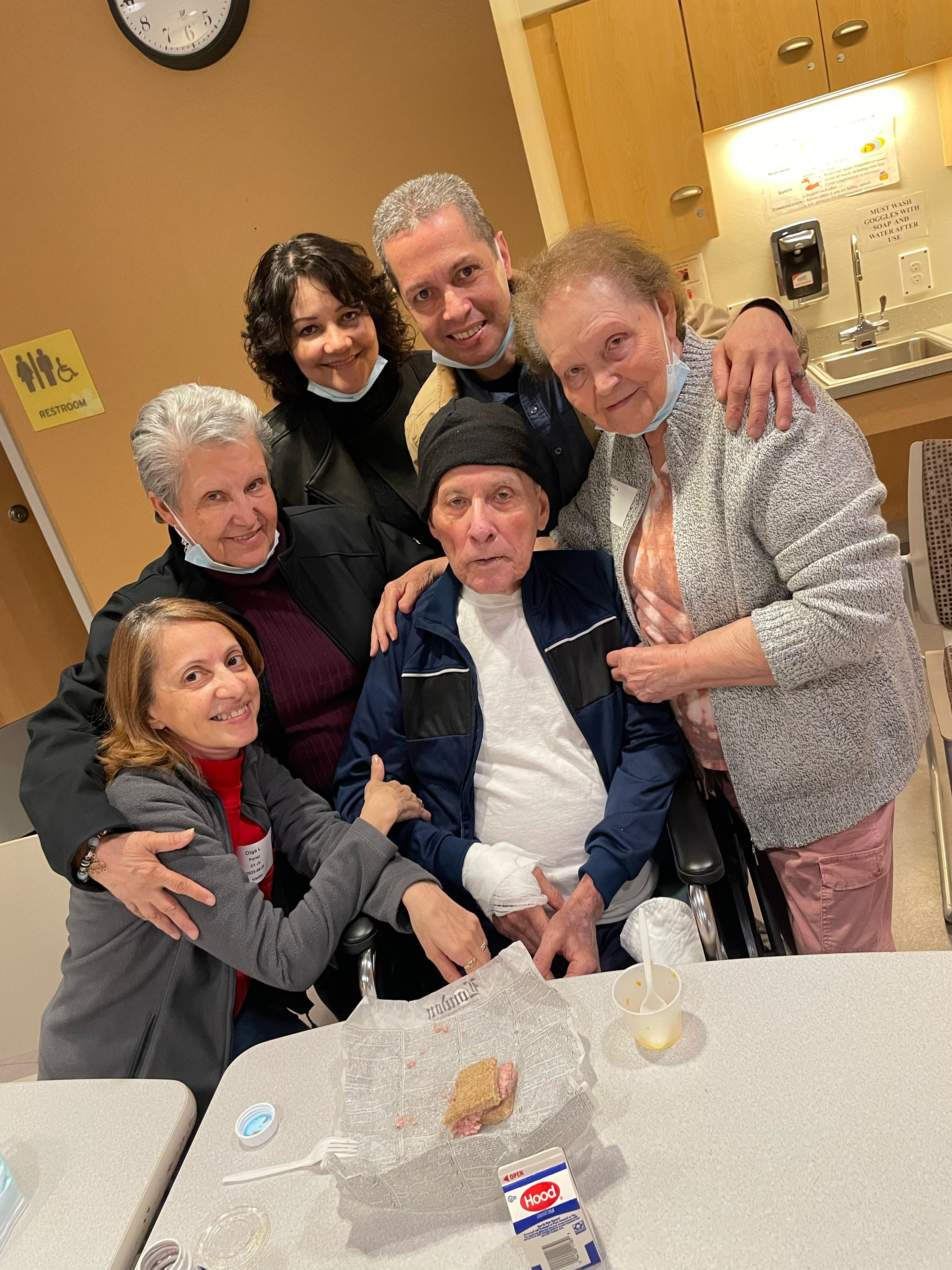 Jose Veguilla, center, with his daughter Olga Perez, far left, and other family members during a visit in May 2023, at the Worcester Recovery Center and Hospital in Worcester, Massachusetts.