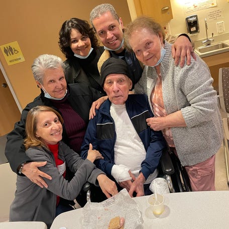 Jose Veguilla, center, with his daughter Olga Perez, far left, and other family members during a visit in May 2023, at the Worcester Recovery Center and Hospital in Worcester, Massachusetts.