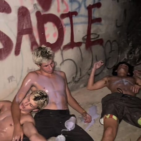 A screengrab from Lucas Robbins's video shows him and his friends covered in the Grimace shake