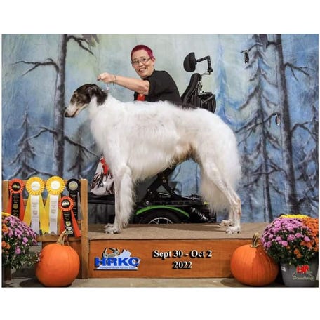 Raina Jones in her wheelchair with her service dog.