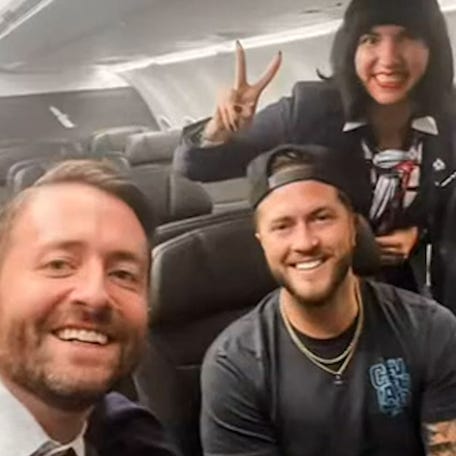 Phil Stringer takes a selfie with the crew of the flight on which he was the only passenger.
