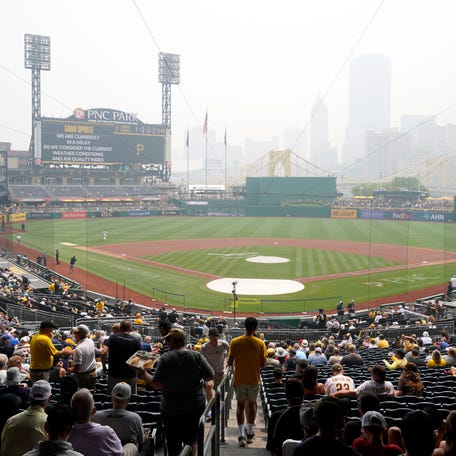 Fans take their seats as the baseball game between the Pittsburgh Pirates and the San Diego Padres is delayed due to haze from Canadian Wildfires, Thursday, June 29, 2023, at PNC Park in Pittsburgh.