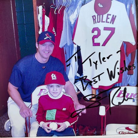 Tyler Frenzel (sitting) with Scott Rolen in the St. Louis Cardinals locker room.