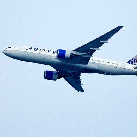 A United Airlines jetliner soars past an MLS soccer match July 8, 2023, in Commerce City, Colo.