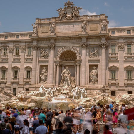 Tourists visit the Trevi Fountain in Rome, Italy on June 30, 2023.