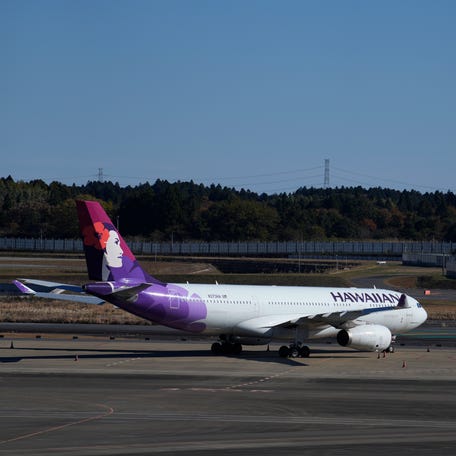 This photo shows a Hawaiian Airlines plane at the Narita International Airport in Narita, east of Tokyo, Thursday, Dec. 2, 2021.