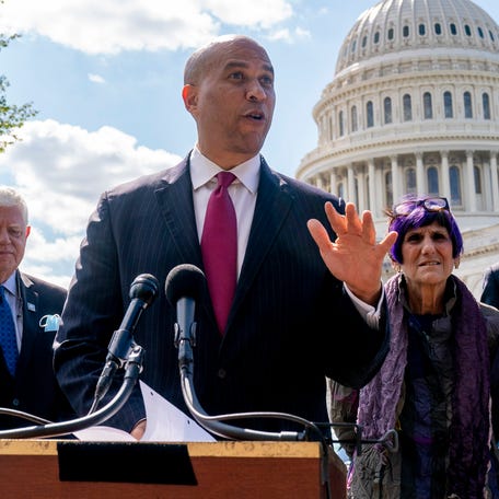 Sen. Cory Booker, D-N.J., center, speaks at a press conference at Capitol Hill in Washington, Thursday, Sept. 30, 2021.