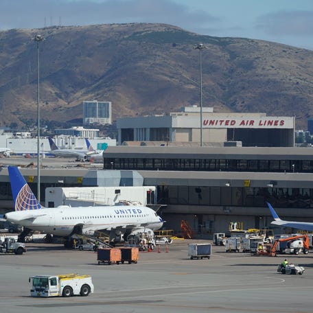 United Airlines planes are seen parked at San Francisco International Airport with a maintenance hangar in the background on Wednesday, July 14, 2021, in San Francisco.