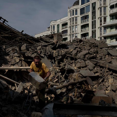A man works on the rubble of an apartment building destroyed in Russian missile attacks in Odesa, Ukraine, Sunday, July 23, 2023.