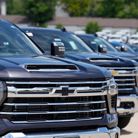 Unsold 2023 Silverado pickup trucks sit in a long row at a Chevrolet dealership on June 18, 2023, in Englewood, Colo.
