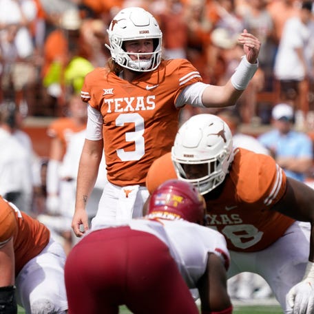 Texas quarterback Quinn Ewers signals at the line of scrimmage during his team's game in 2022 against Iowa State at Darrell K Royal-Texas Memorial Stadium.